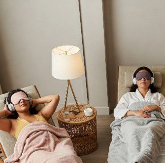 Two people relaxing with eye masks.