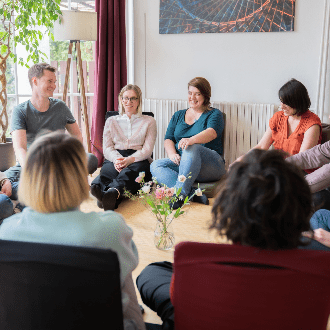 Group discussion in a casual indoor setting.