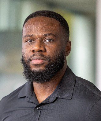 Headshot of bearded man wearing collared shirt